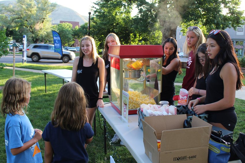 Members of the Golden High School dance team sell popcorn as a fundraiser during the Movies & Music in the Park event Aug. 12 at Parfet Park.